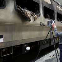 <p>National Transportation Safety Board investigator Kristin Poland sets up 3D Laser Scanner to create model of the damaged rail car. </p>