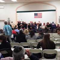 <p>Public officials and clergy gather on stage just before Wednesday night&#x27;s vigil for the Hochman sisters who were murdered on Saturday in Harrison.</p>