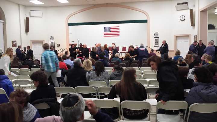 Public officials and clergy gather on stage just before Wednesday night&#x27;s vigil for the Hochman sisters who were murdered on Saturday in Harrison.