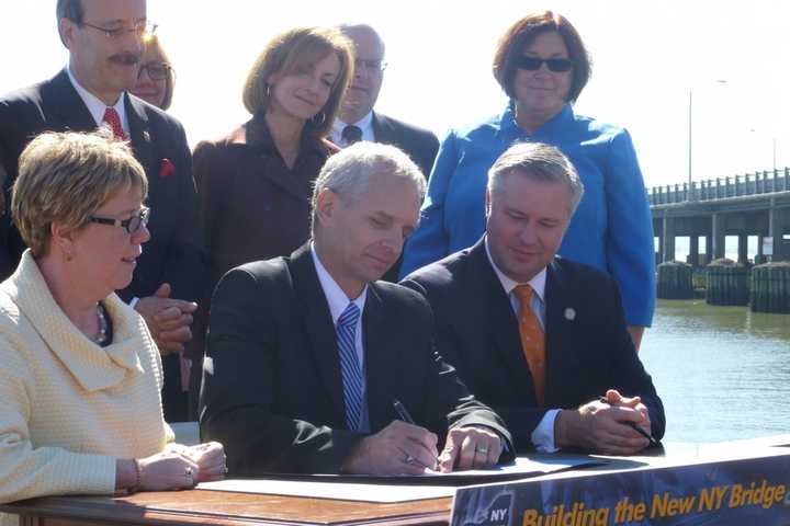 Federal and state officials sign the official record of decision for the Tappan Zee Bridge project in Nyack Tuesday morning.