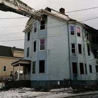 <p>Bridgeport firefighters douse the blaze at a three-story multifamily home on Wednesday afternoon.</p>