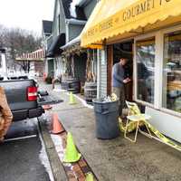 <p>A worker repairs the damage at 109 Cheese &amp; Wine in Ridgefield after a car hit the building Wednesday. </p>