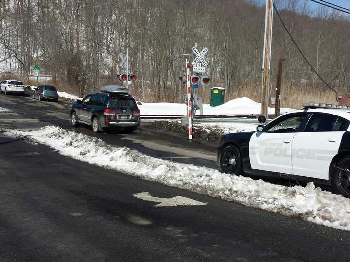 A vehicle was reported to have gotten stuck at a grade crossing in Chappaqua, backed up and broke off a gate, which is pictured at center.