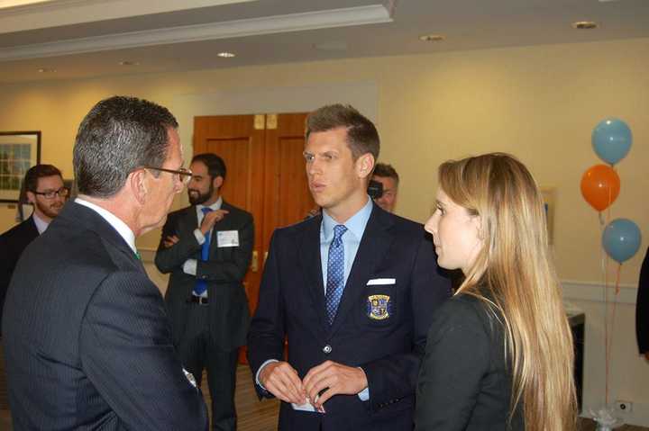 Jamison Monroe, center, talks with Connecticut Governor Dannel P. Malloy at an event in 2014.