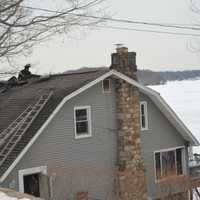 <p>The other side of a fire-damaged home overlooking Lake Mahopac.</p>