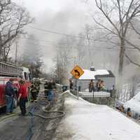 <p>Firefighters battle the blaze in Lake Mahopac.</p>