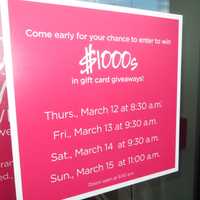 <p>A sign promoting gift card giveaways to celebrate the opening of Saks Fifth Avenue OFF 5TH on Thursday through Sunday mornings.</p>