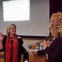 <p>Ellen Lynch, left, president of the Food Bank for Westchester, takes an &quot;eat healthy&quot; oath from Joy Feldman, children&#x27;s author wearing a doughnut hat.</p>