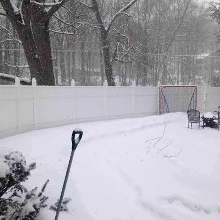 The walkway is covered and the shovel is ready at this Danbury home on Friday afternoon as the snow piles up again. 