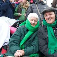 <p>A couple watches the parade.</p>