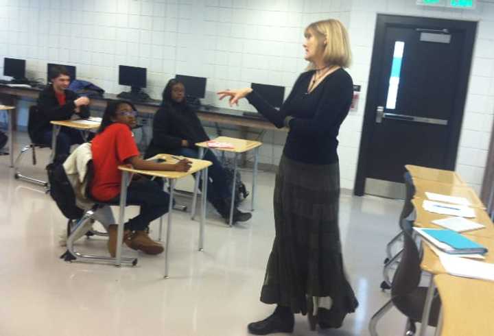 Catherine Brackett leads a &quot;College Forum&quot; class at Wright Technical High School. The Grade 9 students earn a free NCC credit once they complete it successfully.