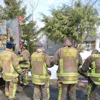 <p>Brewster firefighters prepare to leave after responding to a residential fire at a home overlooking Tonetta Lake.</p>