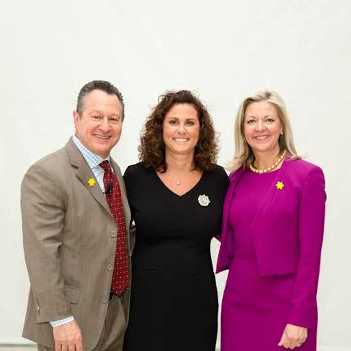 Julianne C. Ward, center, Realtor with BHHSNEPs Greenwich Office, acceptsher award as no. 1 agent in the company with Gino Blefari and Candace Adams.