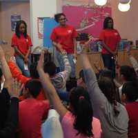 <p>Brookside Elementary students in Norwalk raise their hands in a talk with students from HEART.</p>