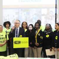 <p>Bruce Ravage, at the microphone, leads a charter school rally Thursday in Bridgeport. </p>