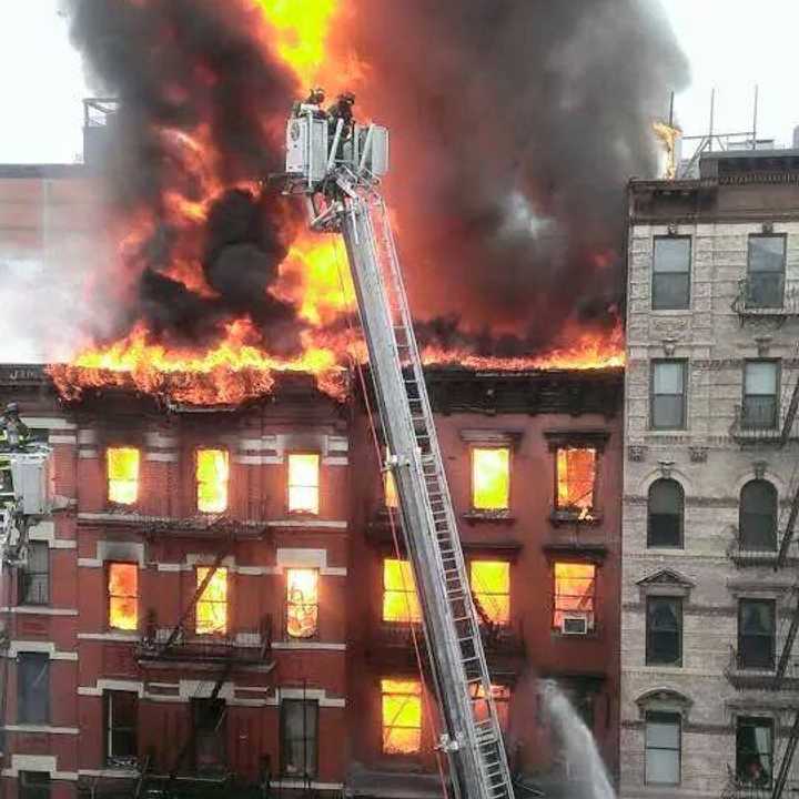 An explosion and five-alarm fire have caused at least one building in Lower Manhattan to collapse. 