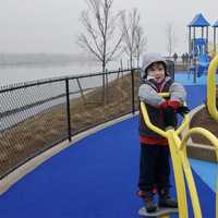 <p>Five-year-old Mason Avery of Greenwich checks out the playground equipment at the new Cos Cob Park in Greenwich. </p>