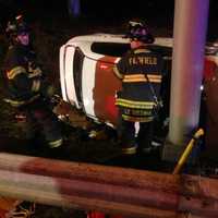 <p>Fairfield and Westport firefighters work together to help victims in a car rollover on I-95. </p>