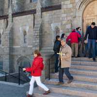 <p>Parishioners leave church with palms on Palm Sunday.</p>