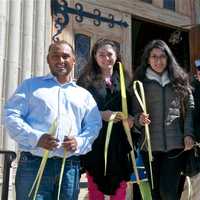 <p>Parishioners leave church with palms on Palm Sunday.</p>