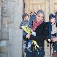 <p>Parishioners leave church with palms on Palm Sunday.</p>