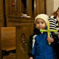 <p>A young boys holds his palm cross at St. Mary&#x27;s on Palm Sunday.</p>