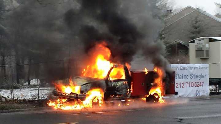 The truck is fully engulfed in flames on East Putnam Avenue in Greenwich on Monday morning.
