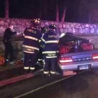 <p>Firefighters work to free the driver, a 27-year-old man. </p>