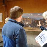 <p>A docent interprets the artwork inside the Young Studio at Weir Farm National Historic Site. </p>