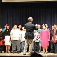 <p>Skip Jennings conducts a choir of his fourth-grade students from Ellsworth Avenue Elementary School. </p>