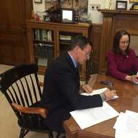 <p>Gov. Dannel Malloy signs the executive order Monday in his office. </p>