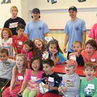 <p>Campers and staff show off their arts and crafts project during 2014 mini camp</p>