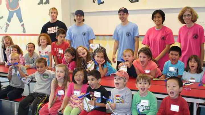 Campers and staff show off their arts and crafts project during 2014 mini camp