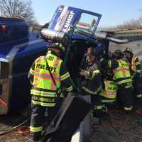 <p>Fairfield firefighters work to free the truck driver. </p>