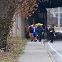 <p>Walkers carry the cross from the First Congregational Church to St. Luke Episcopal on Good Friday.</p>