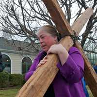 <p>Walkers carry the cross from the First Congregational Church to St. Luke Episcopal on Good Friday.</p>