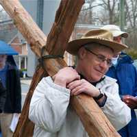 <p>Walkers carry the cross from the First Congregational Church to St. Luke Episcopal on Good Friday.</p>