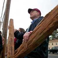 <p>Walkers carry the cross from the First Congregational Church to St. Luke Episcopal on Good Friday.</p>