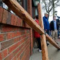 <p>The cross rests on a sidewalk as the group stopped for prayer. </p>