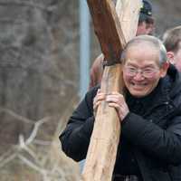 <p>Walkers carry the cross from the First Congregational Church to St. Luke Episcopal on Good Friday.</p>