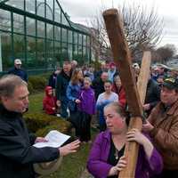 <p>The walkers pause with the cross as the march through Darien to commemorate Good Friday.</p>