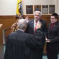 <p>Tuckahoe Mayor Steve Ecklond takes his oath of office with the Rev. Eric Raaser of Immaculate Conception Church.</p>