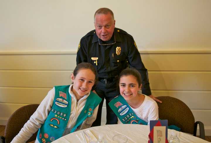 Fairfield Police Department Capt. Joshua S. Zabin enjoys lunch with Scouts Zoe Feay (L) and Emma Fekete.