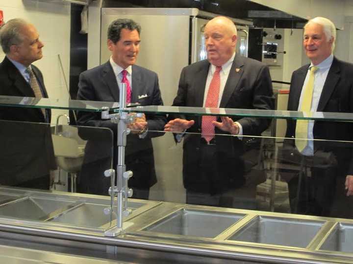 New Covenant House Executive Director John Gutman, Ernie Anastos, Al Barber, president of Catholic Charities and Paul Harinstein, chairman of the board, New Covenant House, tour the soon-to-open expanded New Covenant House facility in Stamford.