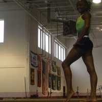 <p>Carlee Reid of Stamford poses on the balance beam.</p>