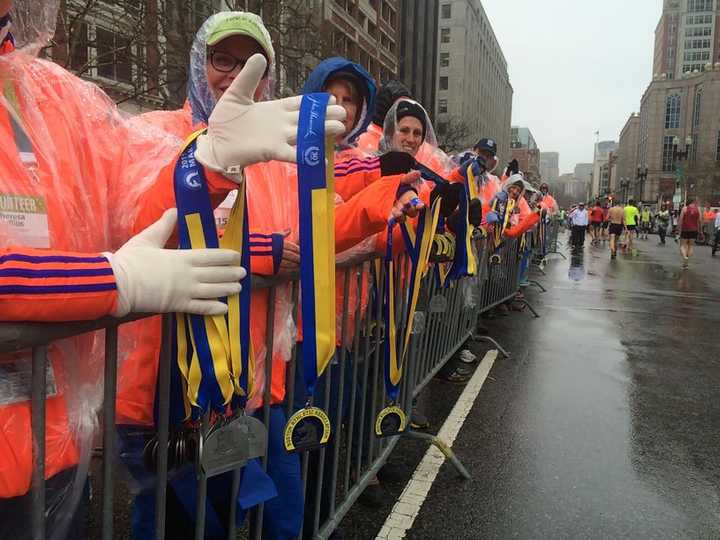 Volunteers wait to distribute medals to finishers at Monday&#x27;s Boston Marathon.