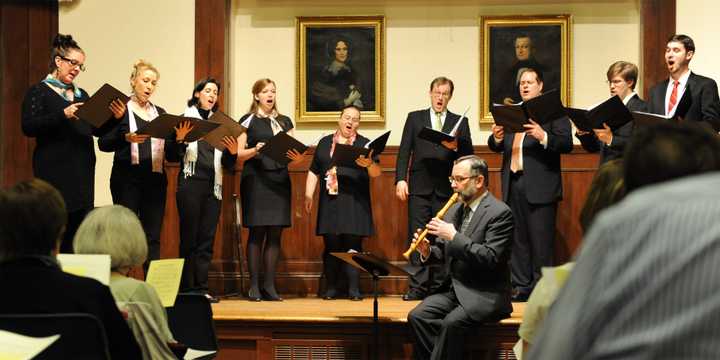 The Music on the Hill Chamber Chorus in performance with Artistic Director David H. Connell, seated, at the Pequot Library in May 2014. 