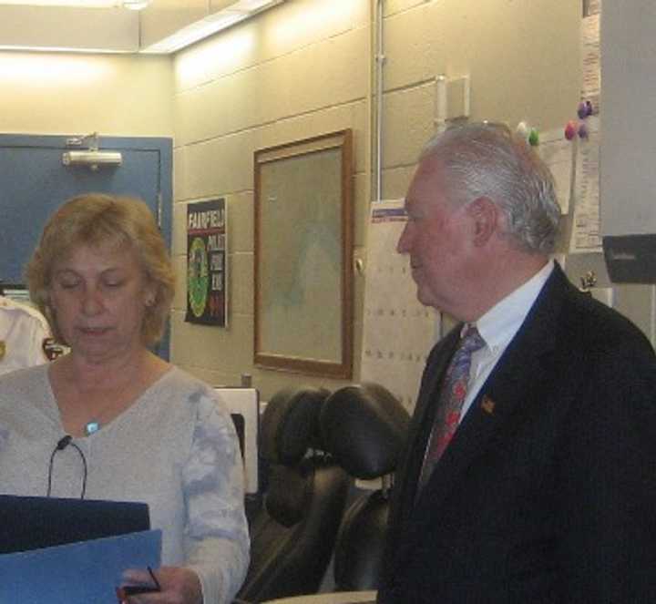 First Selectman Mike Tetreau issues a proclamation to one of the telecommunicators, Liz Rodriguez, who has been with the Emergency Communications Center since it opened 25 years ago. 