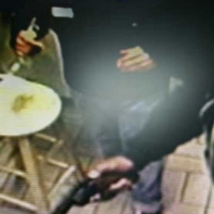 The suspect in the gas station robbery carried a large revolver in his right hand.