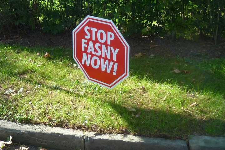 Despite a White Plains Common Council defeat on Aug. 5, signs opposing a new French-American School remain on North Street. FASNY filed a lawsuit on Thursday against the Common Council asking the state Supreme Court to annul its 4-3 vote.